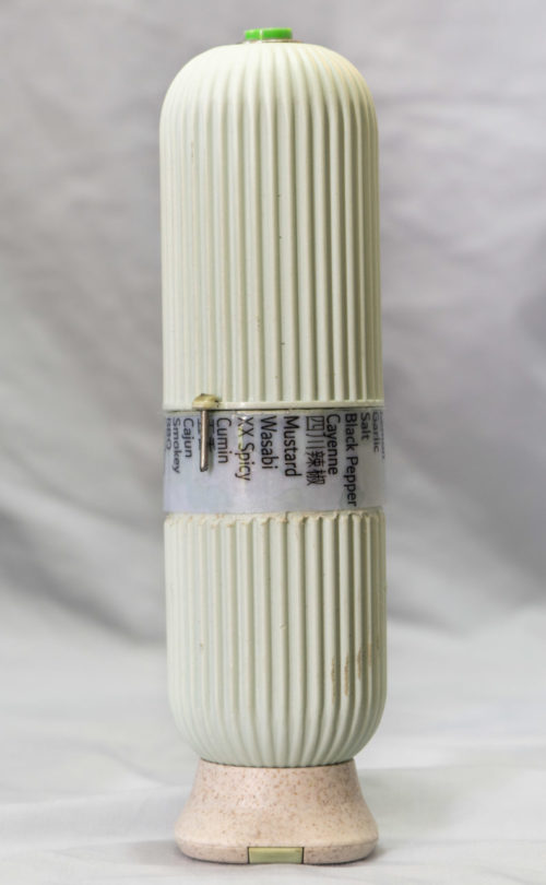 a vertical cylinder with text in the middle and a button on top
